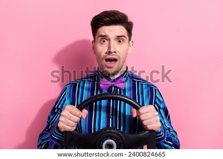 Photo of speechless impressed guy arms hold wheel open mouth unbelievable isolated on pink color background