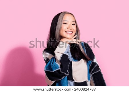 Portrait of optimistic gorgeous woman with dyed hairdo wear oversize sweatshirt hand on chin smiling isolated on pink color background