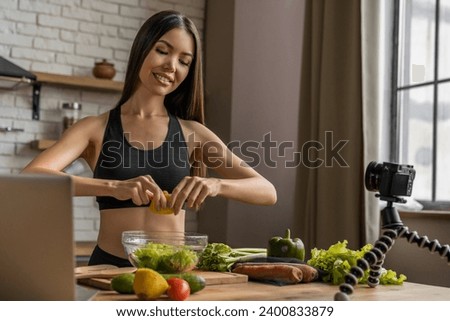 Female food vlogger filming cooking video live on stream talking about detoxication, healthy eating, fresh food, veganism and vegetarianism online for social media