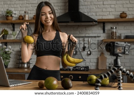 Food blogger recording video on camera at home kitchen about fruits, supplements, dietary healthy eating, veganism and weight loss on stream live vlogging