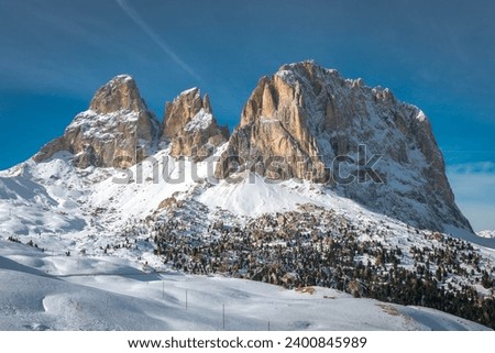 
Snow-capped Sassolungo mountain seen from Passo Sella in the Italian Dolomites. Grohman peak. Royalty-Free Stock Photo #2400845989
