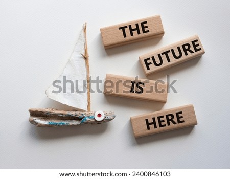The future is here symbol. Concept words The future is here on wooden blocks. Beautiful white background with boat. Business and The future is here concept. Copy space.