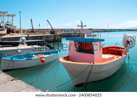 Marina boats docked. Industrial fishing boats are moored in port.