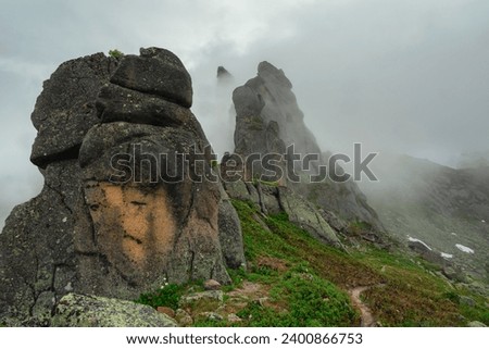 Mountain Face. Spirits of the mountains. Natural scary stone head profile. Stone idols, mystical spirits of the mountains locked in stone. Mystical West Sayans Mountains. Demon in the stone.