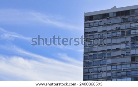 Building with a beautiful blue sky with clouds Royalty-Free Stock Photo #2400868595