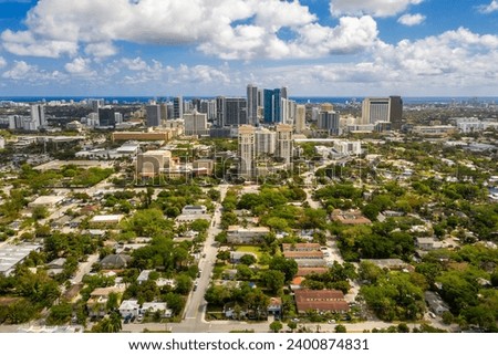 Aerial drone photoshoot Footage in Florida, USA, commercial area, luxury houses, buildings and mansions, abundant tropical vegetation around, beautiful blu sky.