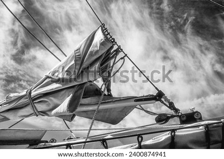 A canvas sail furled on the bow of a sailboat. (Scanned from color film and converted to black and white.)