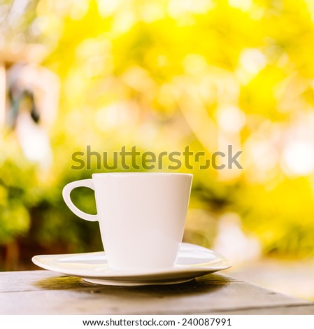 White coffee cup latte on wooden table - vintage sunlight effect style pictures