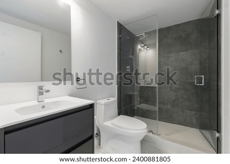 Photoshoot Footage located in Florida, USA. Clean, modern bathroom with refreshing shower, reflecting mirror, Bathtub and sleek tiles. Royalty-Free Stock Photo #2400881805