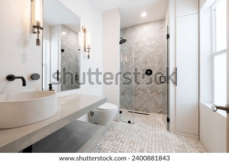 Photoshoot Footage located in Florida, USA. Clean, modern bathroom with refreshing shower, reflecting mirror, Bathtub and sleek tiles. Royalty-Free Stock Photo #2400881843