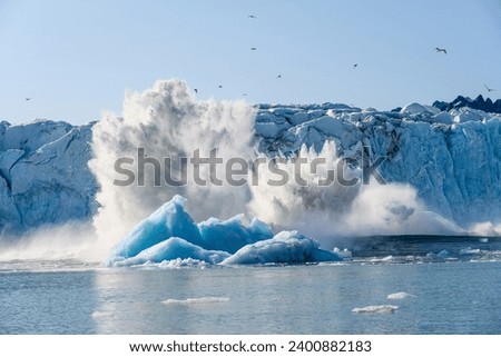 Dramatic ice calving from the Monacobreen Glacier in Liefde Fjord, small tidal wave and icebergs floating in the arctic ocean around Svalbard, signs of climate change and global warming
 Royalty-Free Stock Photo #2400882183