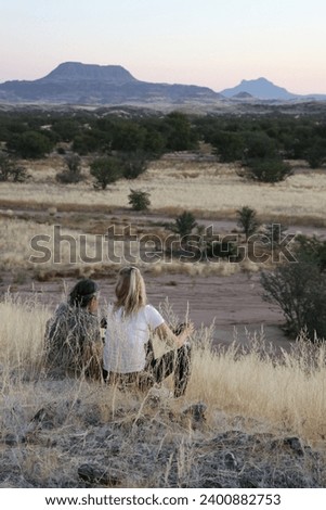 Women looks the view : savannah, valley and elephant - Namibia 