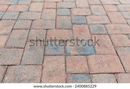 Older paving in a driveway that needs new sealant to protect it from the elements. Royalty-Free Stock Photo #2400885229