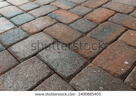 Close up showing driveway area sealant to protect the bricks paving. Sealcoating background for new home construction. Royalty-Free Stock Photo #2400885401