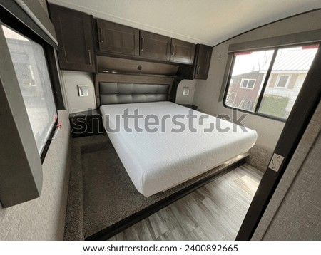 Interior decor and bedroom of a luxury fifth wheel travel trailer or caravan on the road in the southern United States in winter.