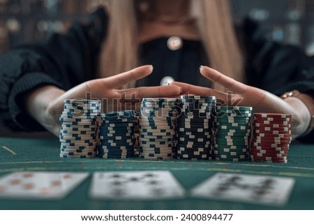 Portrait of young caucasian woman playing poker card game. Gambling concept Royalty-Free Stock Photo #2400894477
