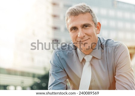 Closeup Of Happy Mature Businessman Smiling Outdoor Royalty-Free Stock Photo #240089569