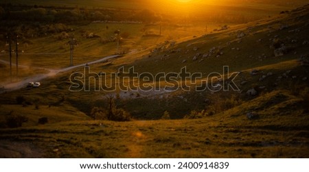 Landscape mountain landscape dusty road in warm sunset backlight
