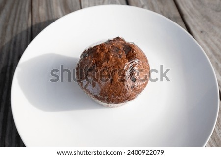 Blueberry muffin on white plate