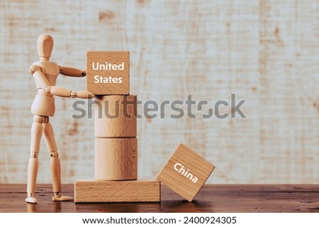 There is wood cube with the word United States or China. It is as an eye-catching image.