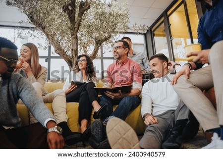 Dynamic Collaboration. Multicultural Business Team Boosting Creative Thinking in Modern Office Space Royalty-Free Stock Photo #2400940579