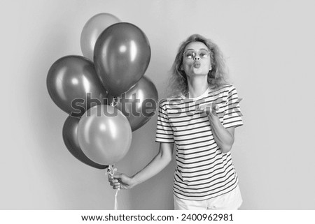 woman blow kiss with birthday balloon in sunglasses. happy birthday woman hold party balloons