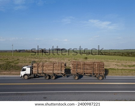 Trucks loaded with tree logs on the road aerial shot