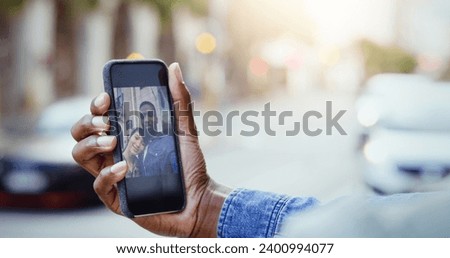 Real life pictures. Shot of a young couple taking a selfie together with a cellphone in the city.