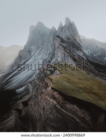 A Mountain Range With A Few Snow On The Top Royalty-Free Stock Photo #2400998869