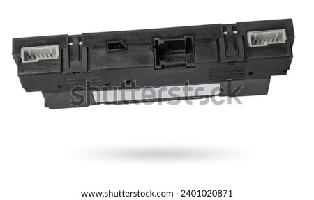Plastic electronic control unit with black and blue connectors on a white isolated background in a photo studio. Spare part for sale or repair of car electronics in a car service.