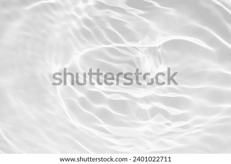 White water with ripples on the surface. Defocus blurred transparent white colored clear calm water surface texture with splashes and bubbles.