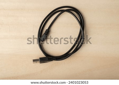 USB charging cable on wooden table