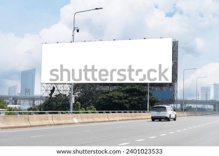 Blank billboard advertising erected outside against a cityscape,copy space for text. Large horizontal blank sign on a highway in Bangkok, Thailand. Traffic and sky.