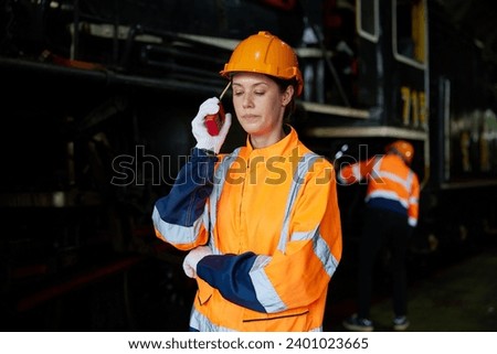 worker using walkie talkie and talking about work at construction train station