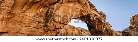 Close up of sandstone arch against blue sky in Capitol Reef national park in Utah, america, usa Royalty-Free Stock Photo #2401030377