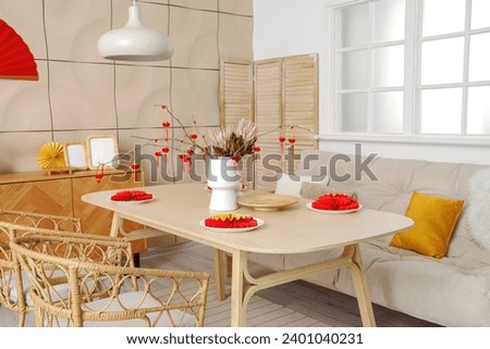 Interior of festive dining room decorated for Chinese New Year celebration Royalty-Free Stock Photo #2401040231