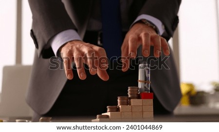 Male arm in suit reach for money closeup. Participant in financial pyramid did not have time to collect his money at moment when everything collapsed concept. Royalty-Free Stock Photo #2401044869