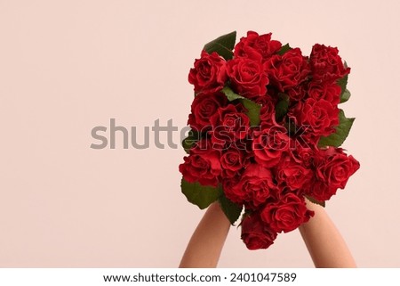 Female hands with bouquet of beautiful red roses on white background. Valentine's day celebration Royalty-Free Stock Photo #2401047589