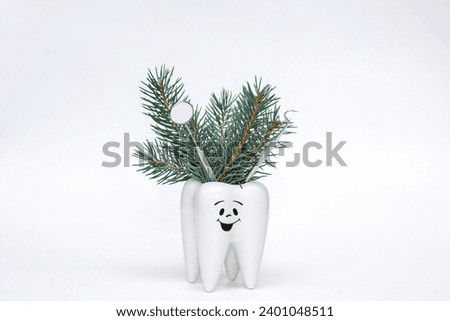 smiling healthy tooth with Christmas tree and dentist tools. Christmas or New Year gift for dentist