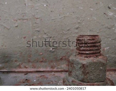 Rusty bolts at the base of the support posts