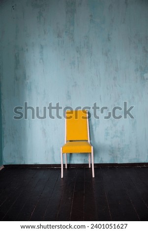 yellow chair in turquoise room
