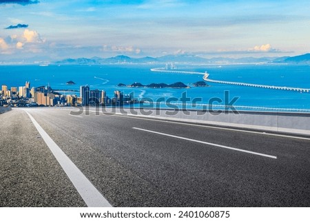 Asphalt highway road and beautiful coastline natural landscape at sunset in Zhuhai, China. High angle view.