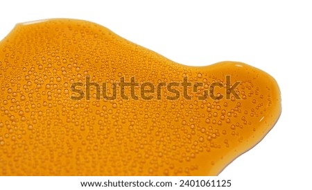 Isolated spilled cola with small bubbles on white background.