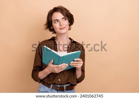 Photo of charming thoughtful lady wear brown shirt enjoying good story looking empty space isolated beige color background