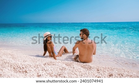 Golfo di Orosei Sardina a man and women on the beach in Sardinia Italy, a young couple on vacation in Sardinia Italy,  Royalty-Free Stock Photo #2401074941
