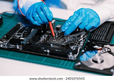 The technician is putting the CPU on the socket of the computer motherboard. electronic engineering electronic repair, electronics measuring and testing, repair in shop

