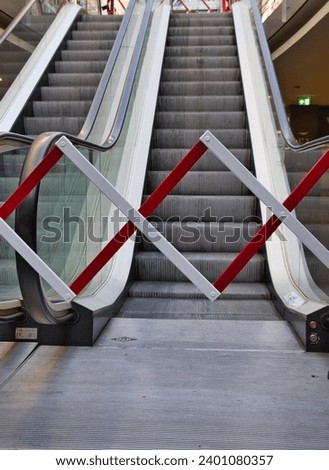 barrier fence in front of an escalator