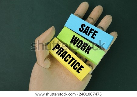 wooden hand and colored paper with the words safe work practices. the concept of work instructions
