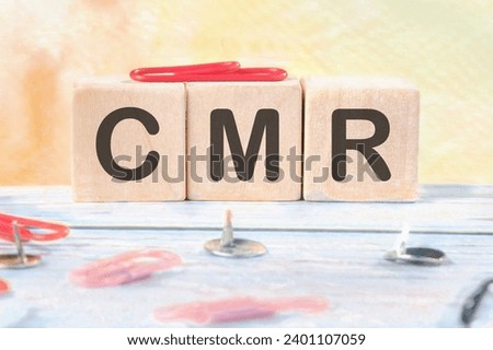 CMR Contract Management Review or Clear Motion Rate signs on wooden cubes on a light background.