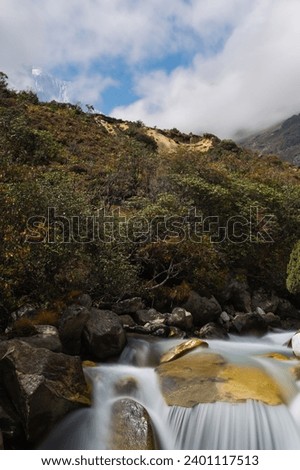 View of Bhote Koshi river in a clear day in Thame during Three passes trekking in Himlayas, Khumbu region, Nepal, Asia. Long exposure photography.